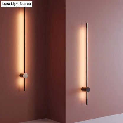 Modern black and white led metal wall sconce with warm linear light strip for indoor lighting in living room