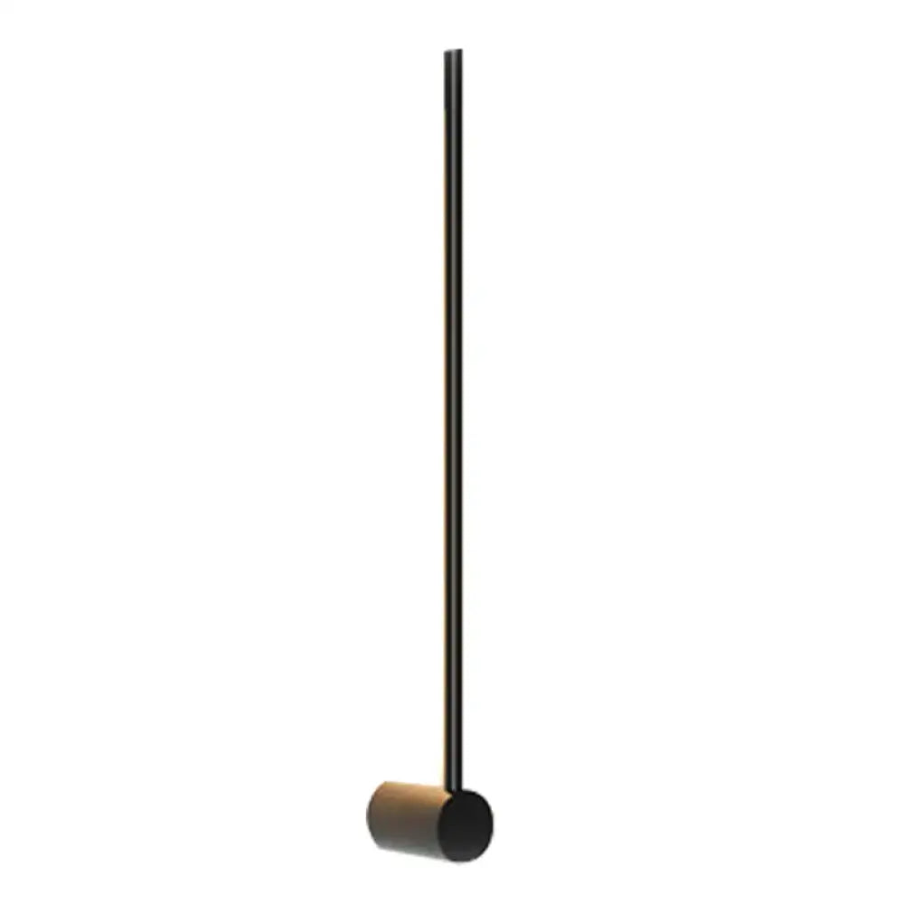 Black metal mallet with cylindrical wooden head displayed alongside modern black and white led metal wall sconce indoor lighting