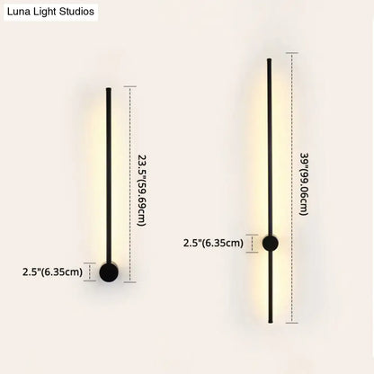 Modern black and white led metal wall sconce with sleek cylindrical design and warm indoor lighting for living room
