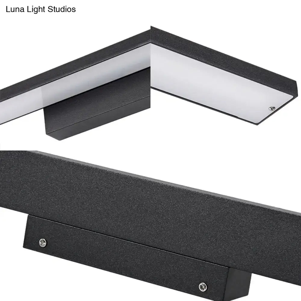 Modern black and white led vanity lamp featuring a sleek rectangular black light fixture with textured surface for bathroom use
