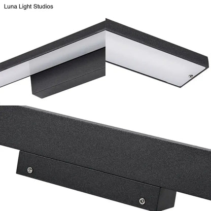Modern black and white led vanity lamp featuring a sleek rectangular black light fixture with textured surface for bathroom use