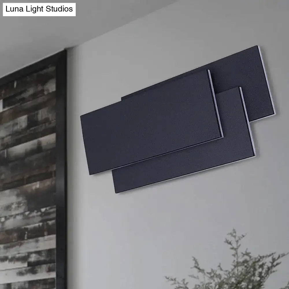 Modern black and white wall lamp with sleek metallic edges and a fixture height of 5in for bedroom use
