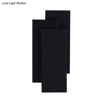 Modern black and white wall lamp with minimalist design and fixture height of 5in for bedroom lighting
