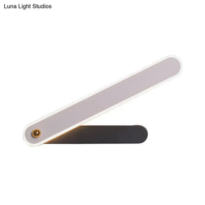 Modern black and white led wall mount fixture with sleek white and matte black finish and elegant angular design