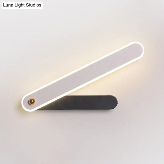 Modern black and white led wall mount fixture with sleek design and illuminated edge casting warm light for bedroom use