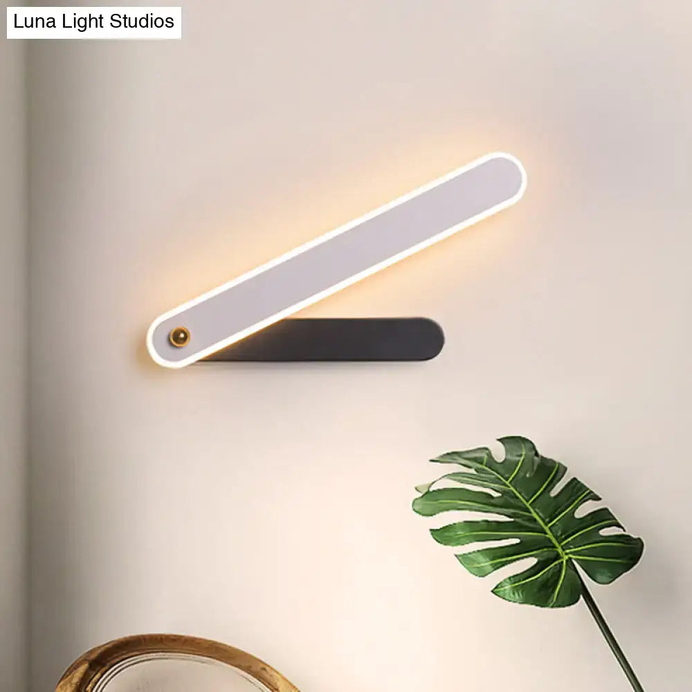 Modern black and white led wall mount fixture with sleek design and warm illuminated led strip for bedroom sconce