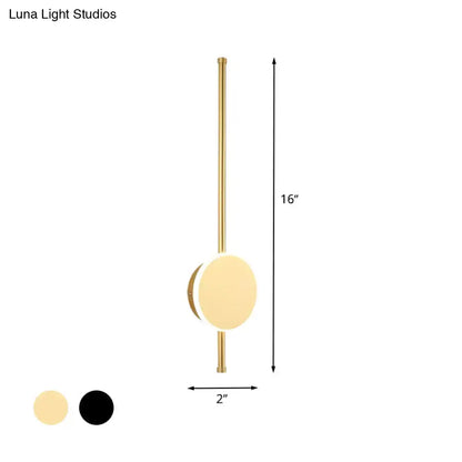 A sleek 16-inch brass-finished wall sconce with minimalist circular light and warm color temperature for bedrooms