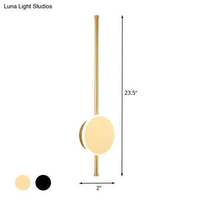 Modern gold-finished wall sconce with frosted glass diffuser and vertical stem featuring warm color temperature lighting