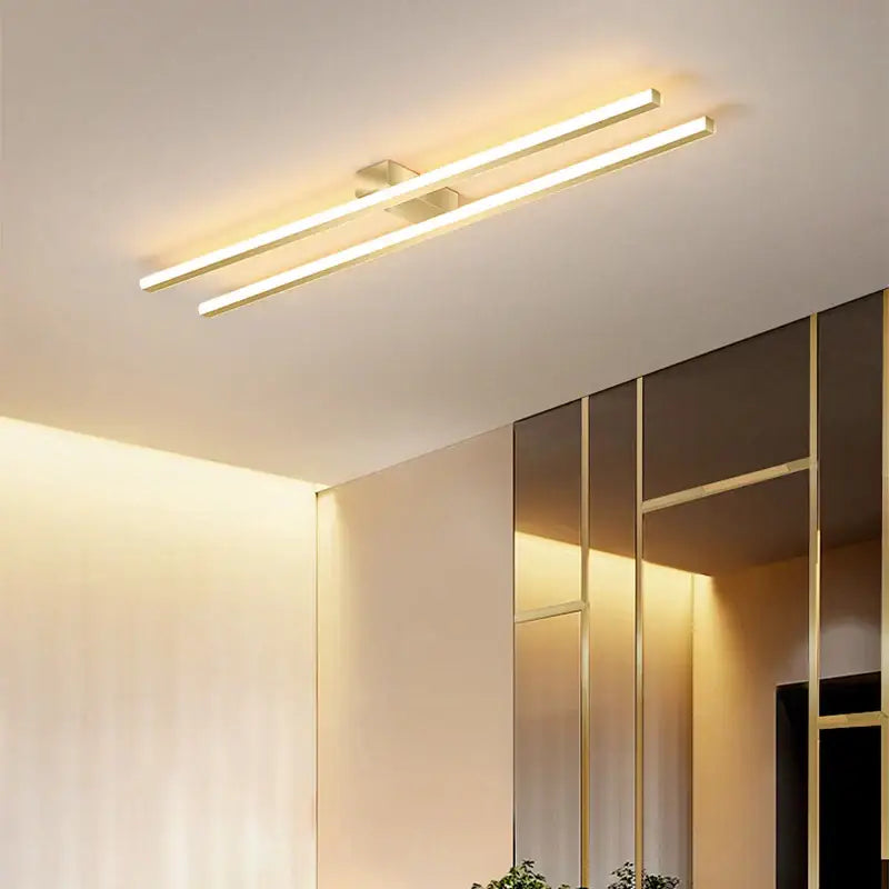 Modern black and white linear led ceiling light with gold-finished bars emitting warm ambient light for living room decorbites led ceiling