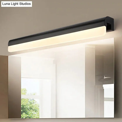 Modern black and white linear led wall light with sleek rectangular design mounted above a bathroom vanity mirror