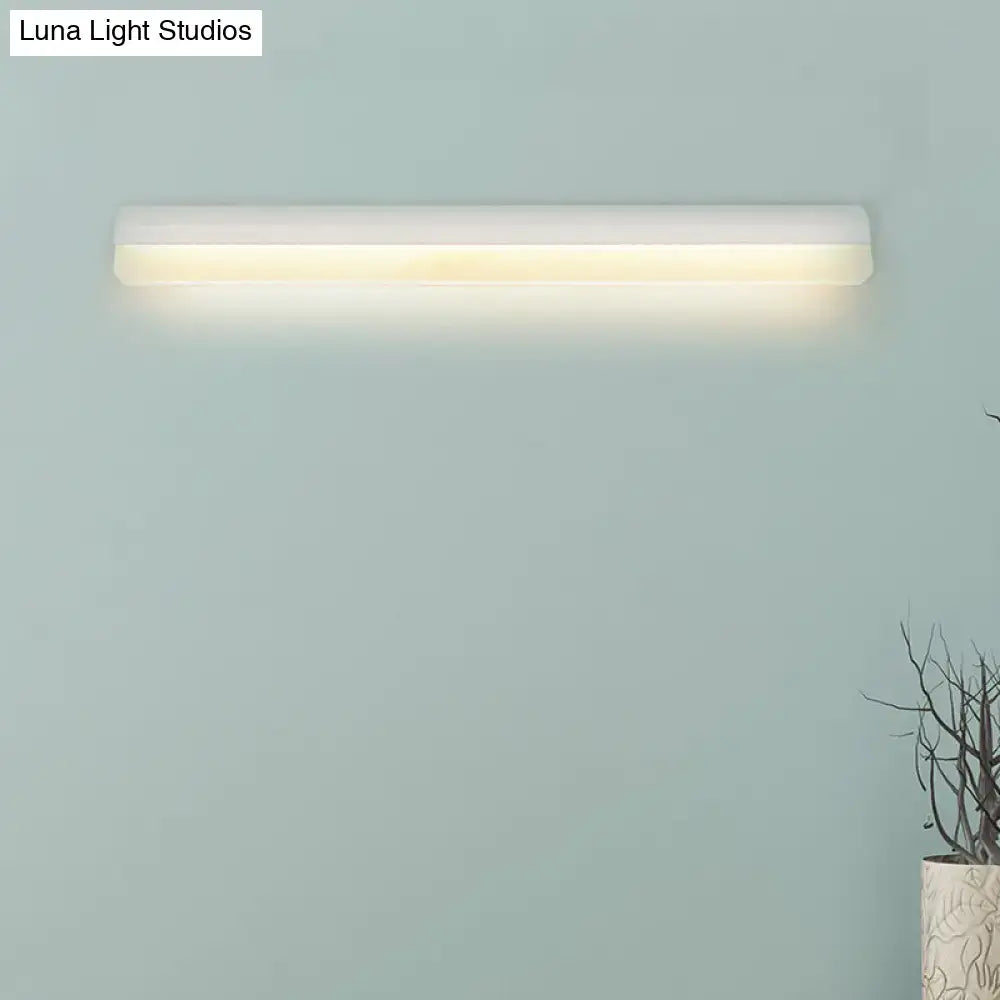 Modern black and white linear led wall light bathroom sconce with sleek white rectangular design emitting warm ambient lighting