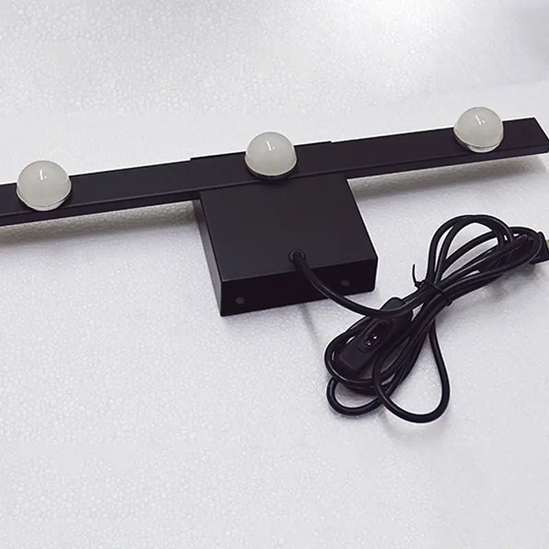 Modern black and white linear wall lighting with three frosted globe bulbs and a coiled power cord for warm white light