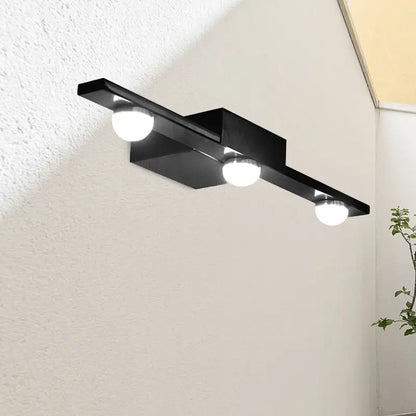 Modern black wall lighting with three spherical bulbs emitting warm white light for bathroom vanity use