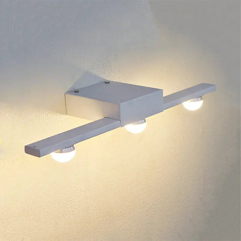 Modern black and white linear wall lighting bathroom vanity light with three white spherical bulbs emitting warm white light