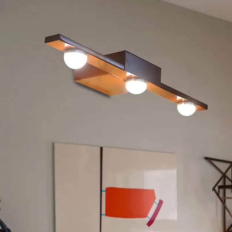Modern black and white linear wall lighting bathroom vanity light with a dark bronze and warm copper-toned finish emitting warm white light