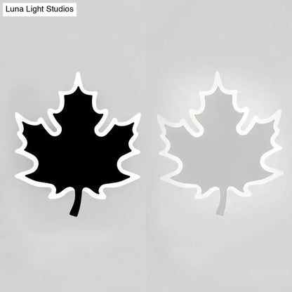 Modern black and white maple leaf sconce light with sleek white outline and illuminated black or translucent interior wall decor