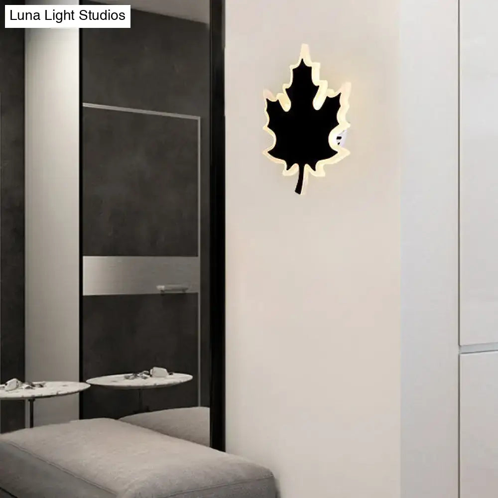 Modern black and white maple leaf sconce light with glowing white backlight for bedroom wall decor