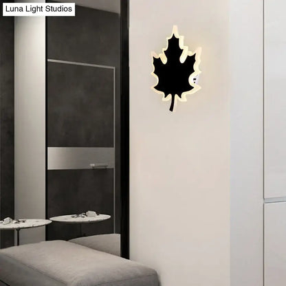 Modern black and white maple leaf sconce light with glowing white backlight for bedroom wall decor