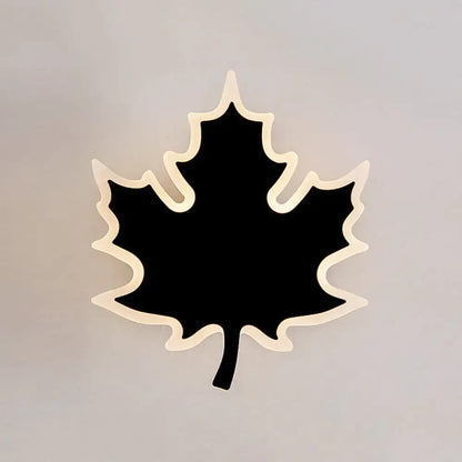 Modern black maple leaf sconce light with glowing cream outline ideal for bedroom wall decor and ambiance