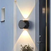 Modern black and white mini cube wall lamp with black cylindrical dual angled lights illuminating living room wall lamp