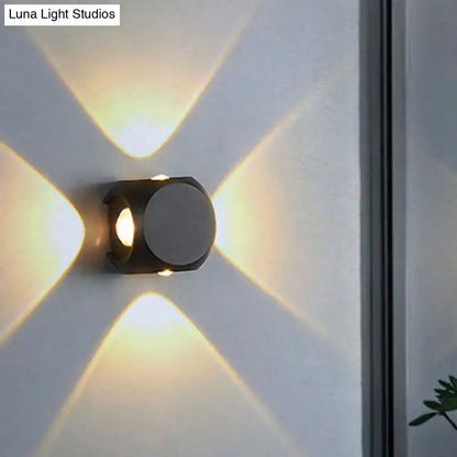 Modern black and white mini cube wall lamp with geometric design casting warm light patterns for living room use