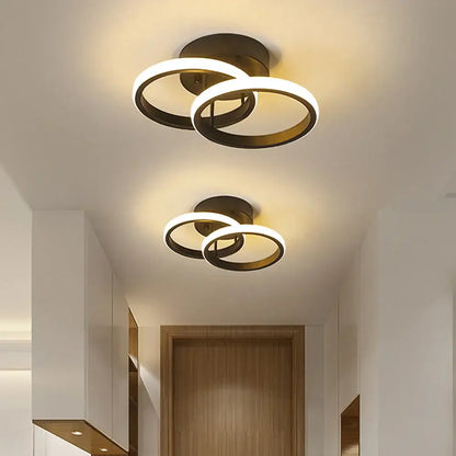 Modern black and white minimalist led ceiling light with two interlocking brushed brass rings warm glow decorbites led ceiling