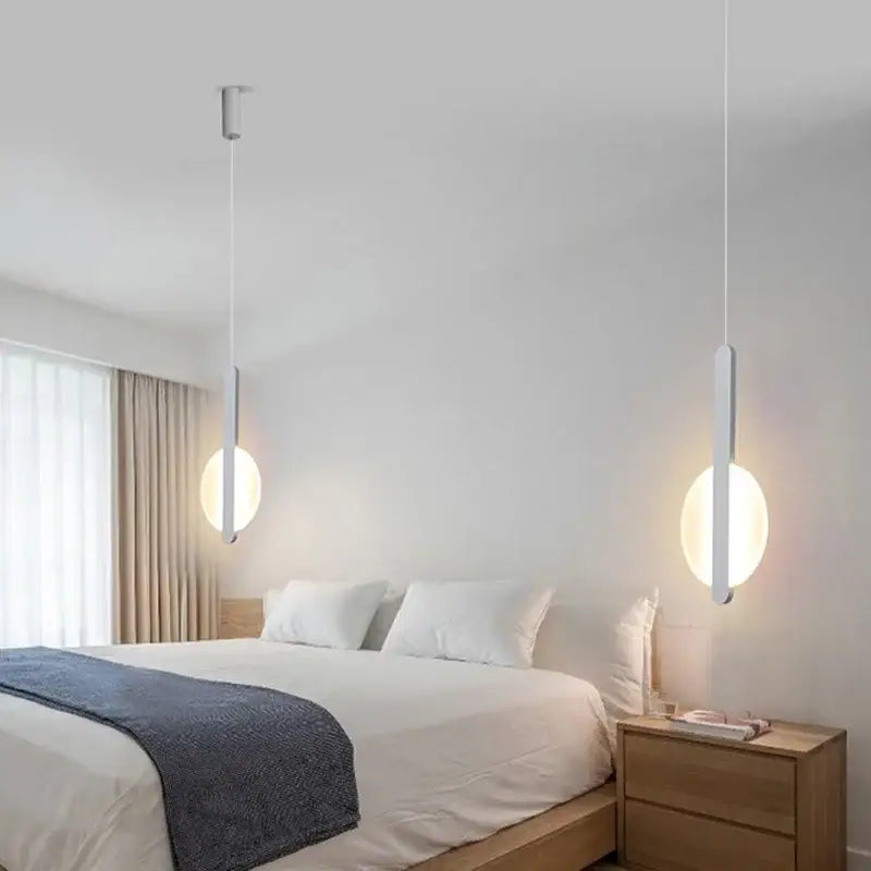 Modern black and white minimalist pendant light with led bulbs featuring sleek white cylindrical shades and warm light source