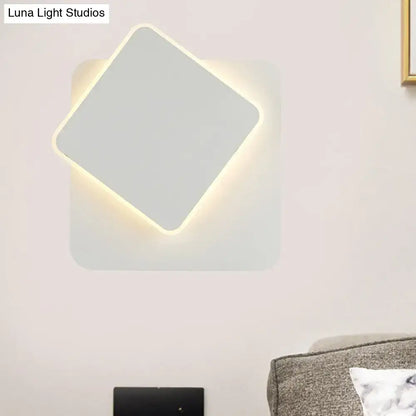 Modern black and white minimalist wall lamp with sleek white finish and softly glowing led light edge for bedroom use