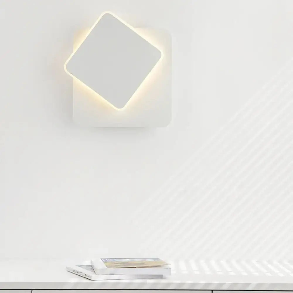 Modern black and white minimalist led wall lamp featuring a white square wall sconce with softly glowing led light
