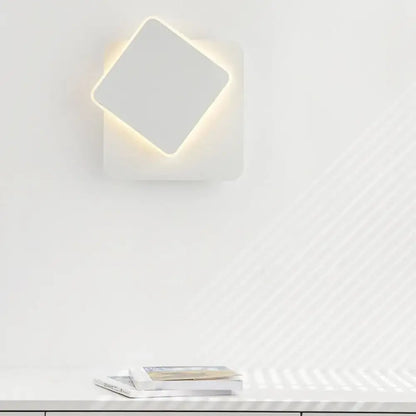 Modern black and white minimalist led wall lamp featuring a white square wall sconce with softly glowing led light