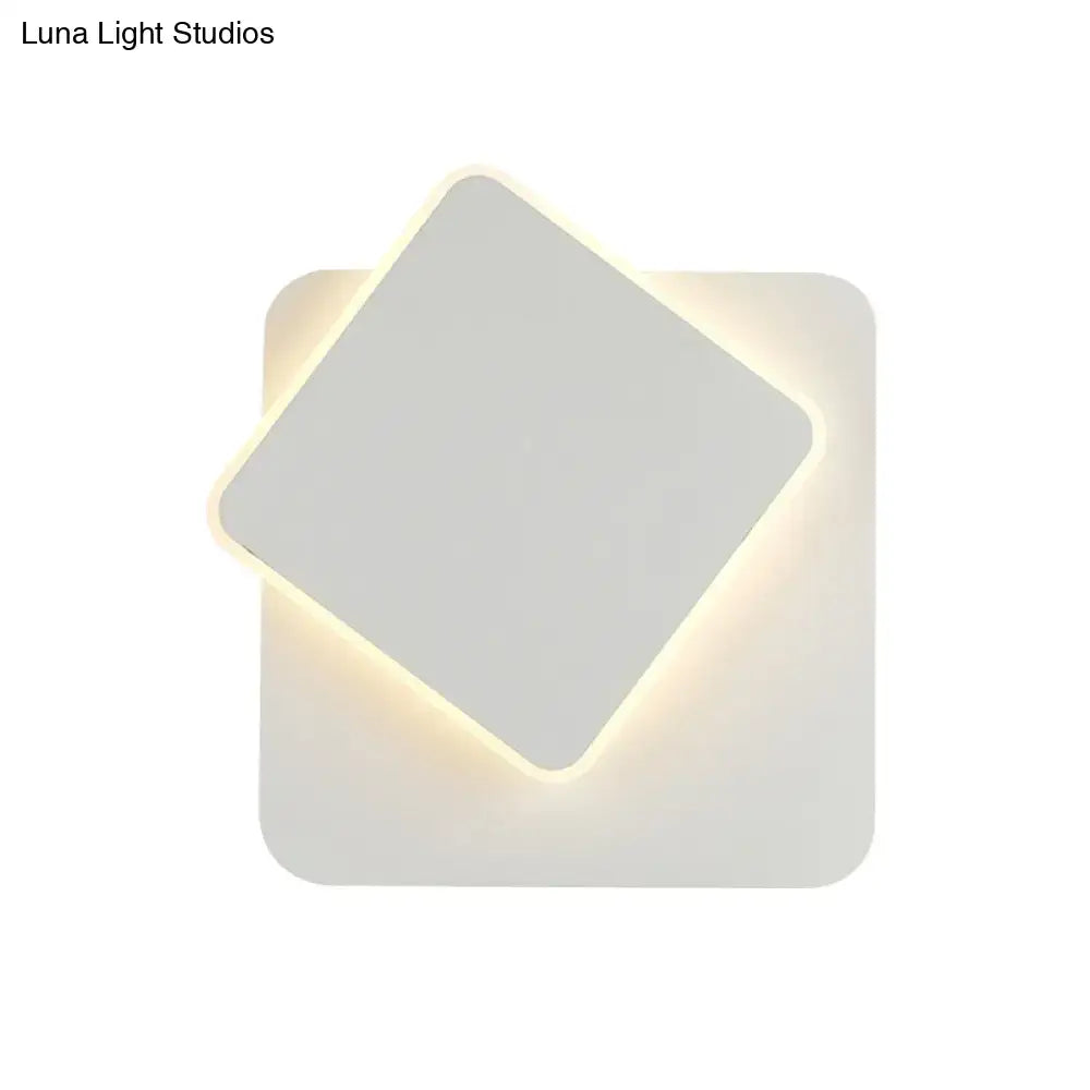 Modern black and white minimalist led wall lamp with two overlapping square panels emitting soft warm light