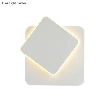 Modern black and white minimalist led wall lamp with two overlapping square panels emitting soft warm light