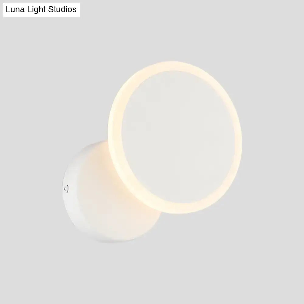 Modern black and white minimalist led wall sconce with a sleek white circular design and warm ambient lighting for living room