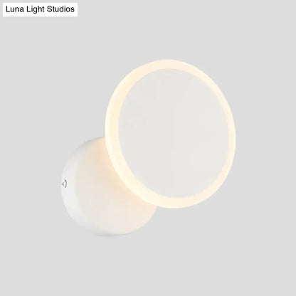 Modern black and white minimalist led wall sconce with a sleek white circular design and warm ambient lighting for living room