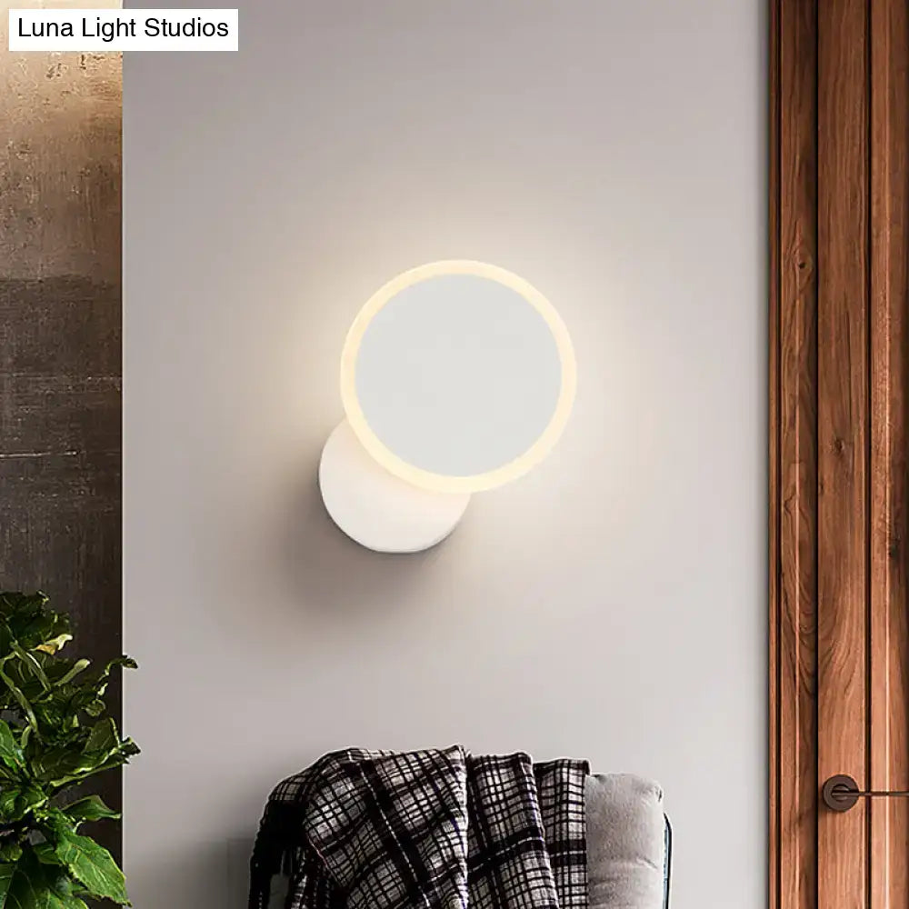 Modern black and white minimalist led wall sconce with a glowing circular ring light for living room lighting in modern style