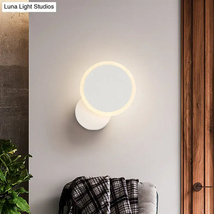 Modern black and white minimalist led wall sconce with a glowing circular ring light for living room lighting in modern style