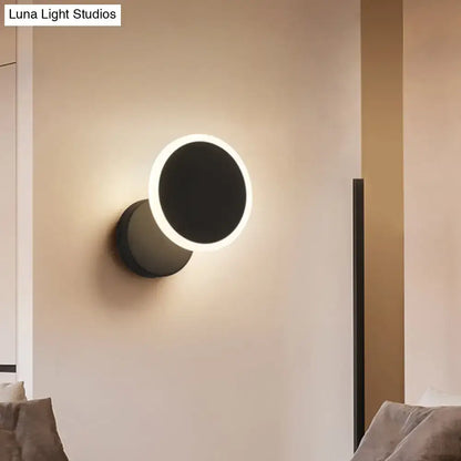 Modern black and white minimalist led wall sconce with sleek matte finish and illuminated ring for living room lighting