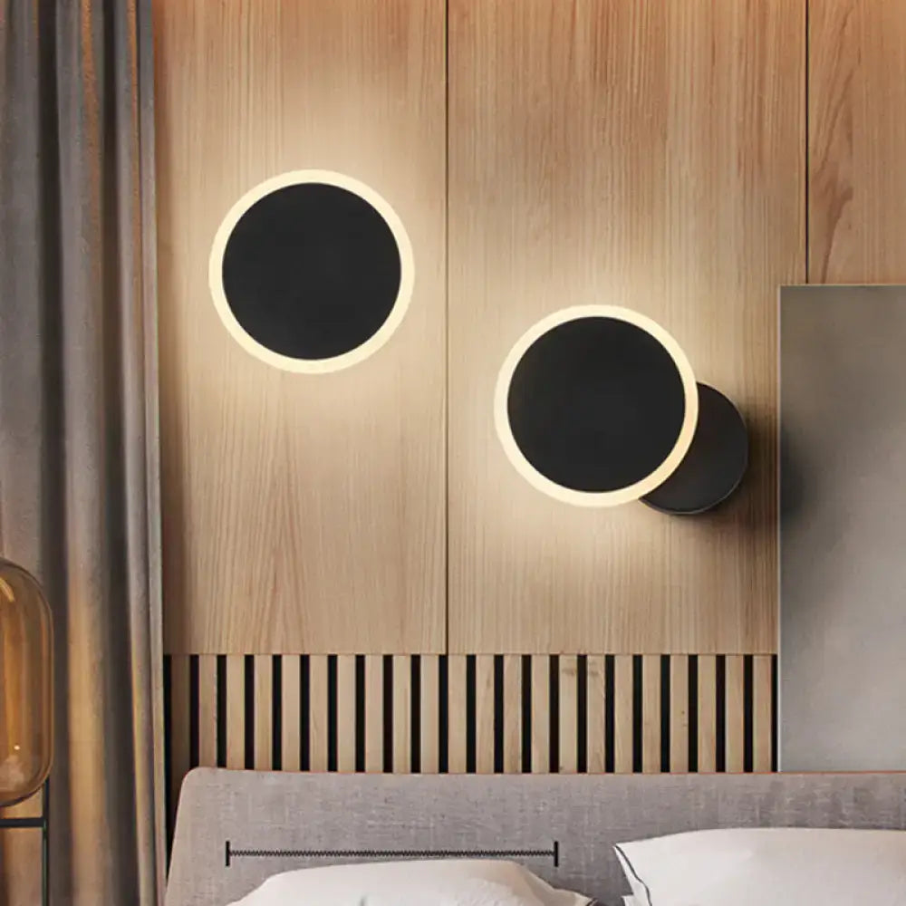 Modern black and white minimalist led wall sconce with black matte center and warm glowing led ring for living room lighting