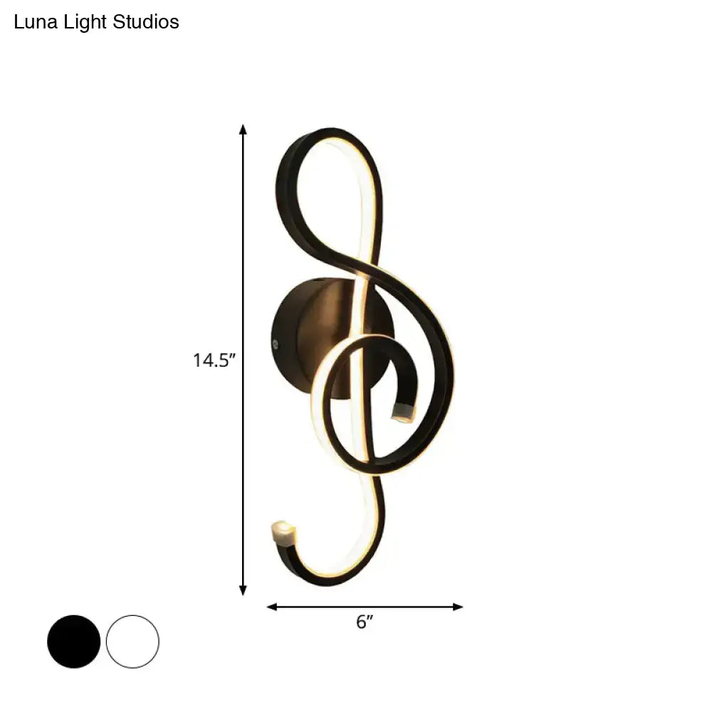 Modern black and white wall lamp shaped like a musical note with an acrylic shade for bedroom lighting