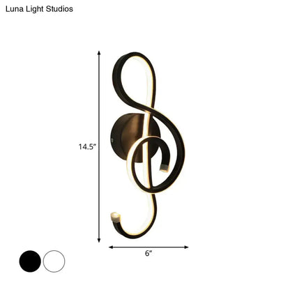 Modern black and white wall lamp shaped like a musical note with an acrylic shade for bedroom lighting