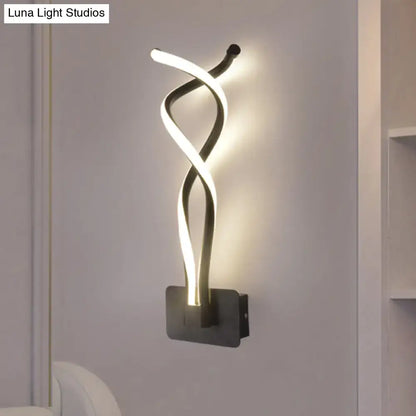 Modern black wall lamp with a sleek twisted led light design and white acrylic shade featuring a musical note motif