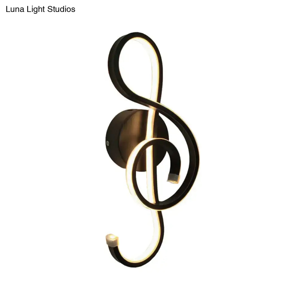 Modern black and white wall lamp shaped like a musical note with illuminated acrylic shade for bedroom use
