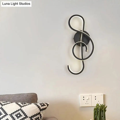 Modern black and white wall lamp shaped like a musical note with acrylic shade for bedroom decor