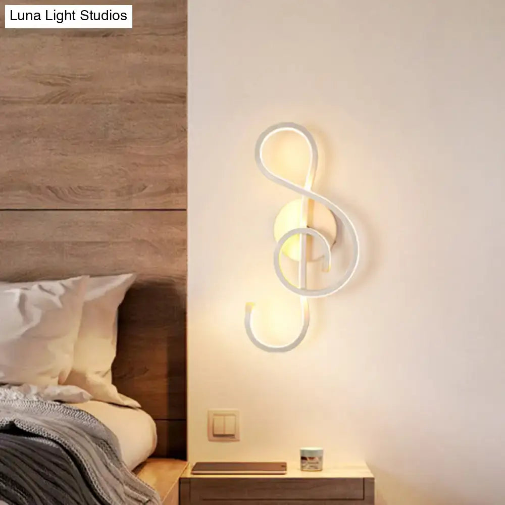 Modern black and white wall lamp shaped like a musical note with acrylic shade for bedroom lighting