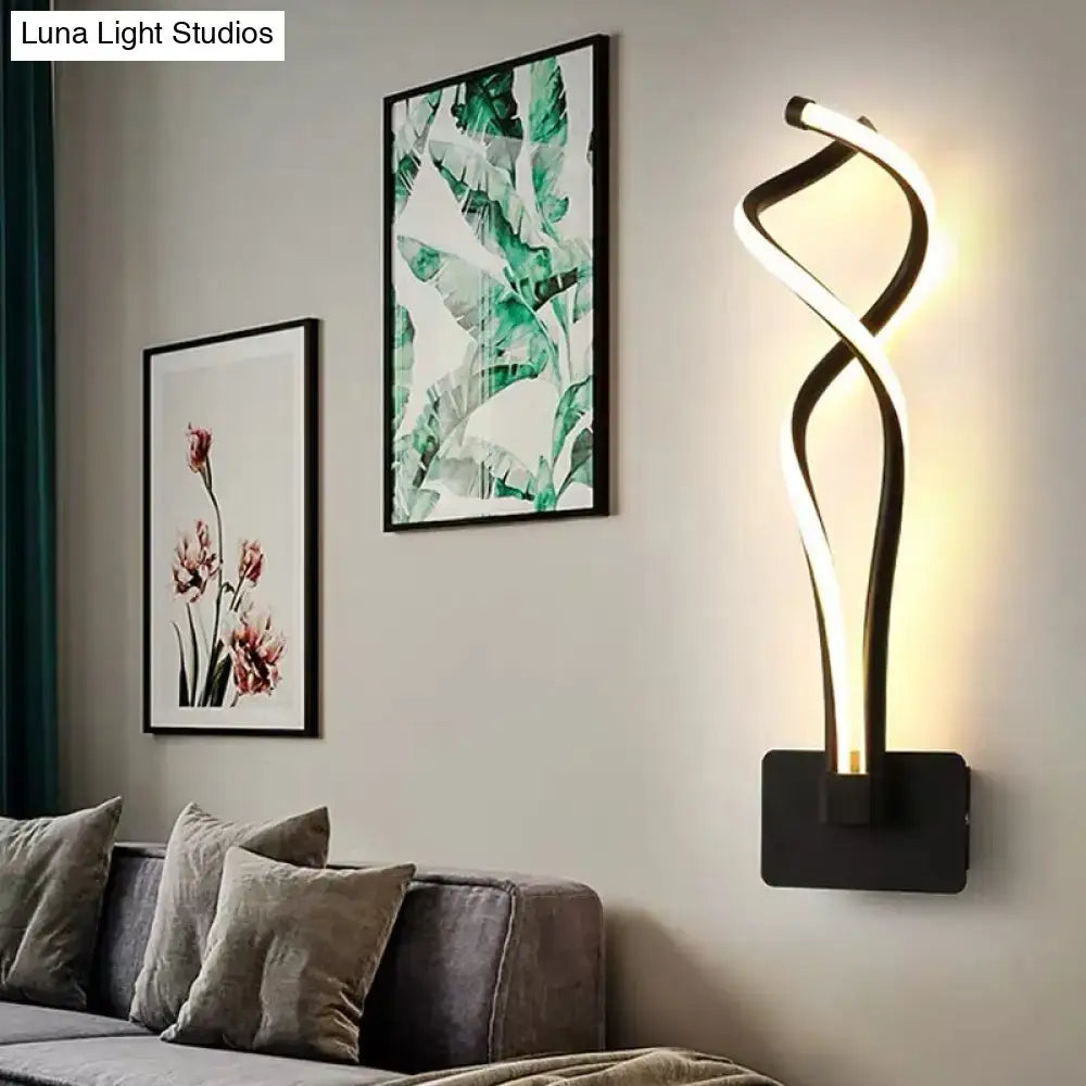 Modern black and white wall lamp with a twisting musical note design and acrylic shade for bedroom lighting