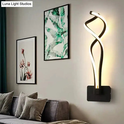 Modern black and white wall lamp with a twisting musical note design and acrylic shade for bedroom lighting