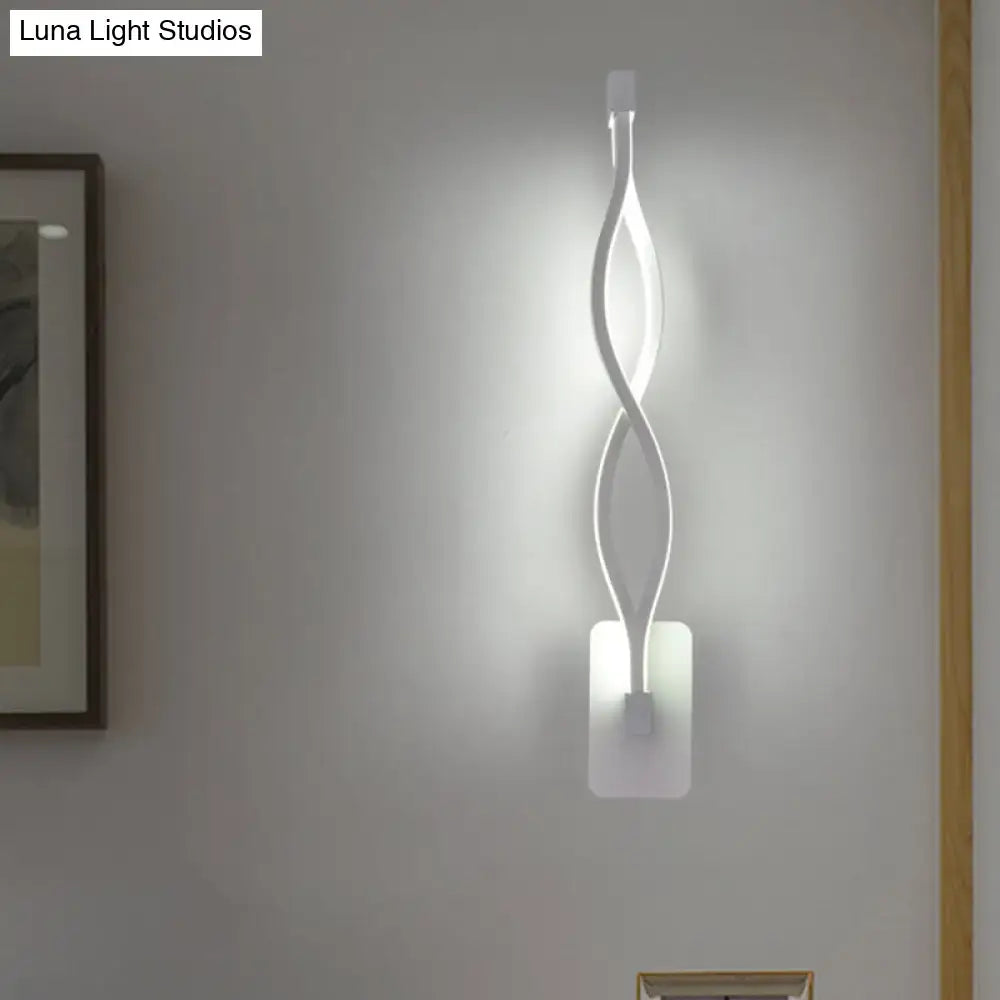 A sleek white wall lamp with a modern twisted design and acrylic shade resembling a musical note for bedroom use