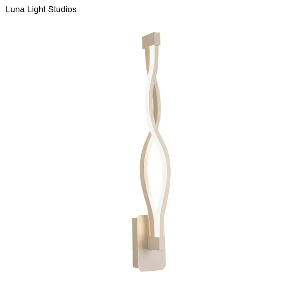 Modern black and white wall lamp with a sleek twisted led design and an acrylic shade for bedroom use