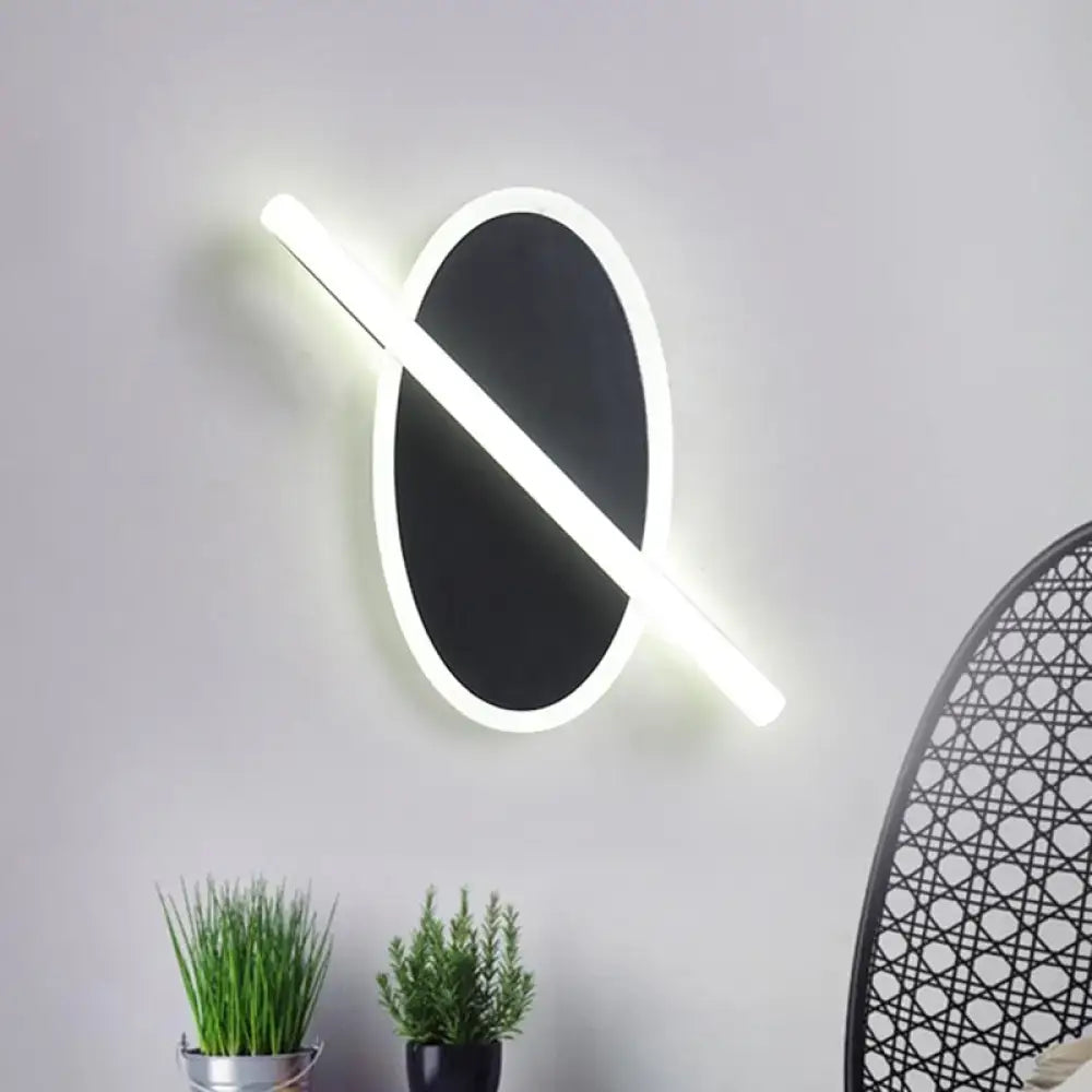 Modern black and white oval led sconce with a white warm glowing light strip for stairway illumination