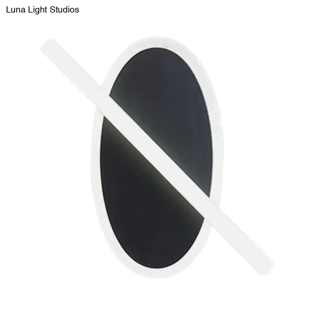 Modern black and white oval led sconce with white border and diagonal stripe for warm white stairway lighting